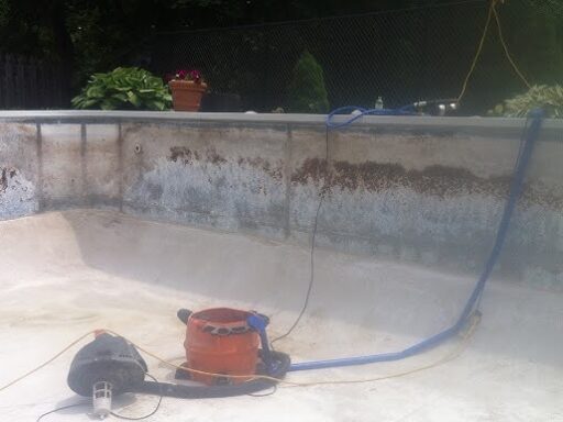 An empty pool with tools to detect leaks in it